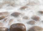 Ireland-Kinard Close-up of wave on smooth beach rocks Art Print
